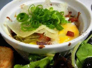 Baked Eggs and Bacon Cream In Spinach Fettuccine Nests
